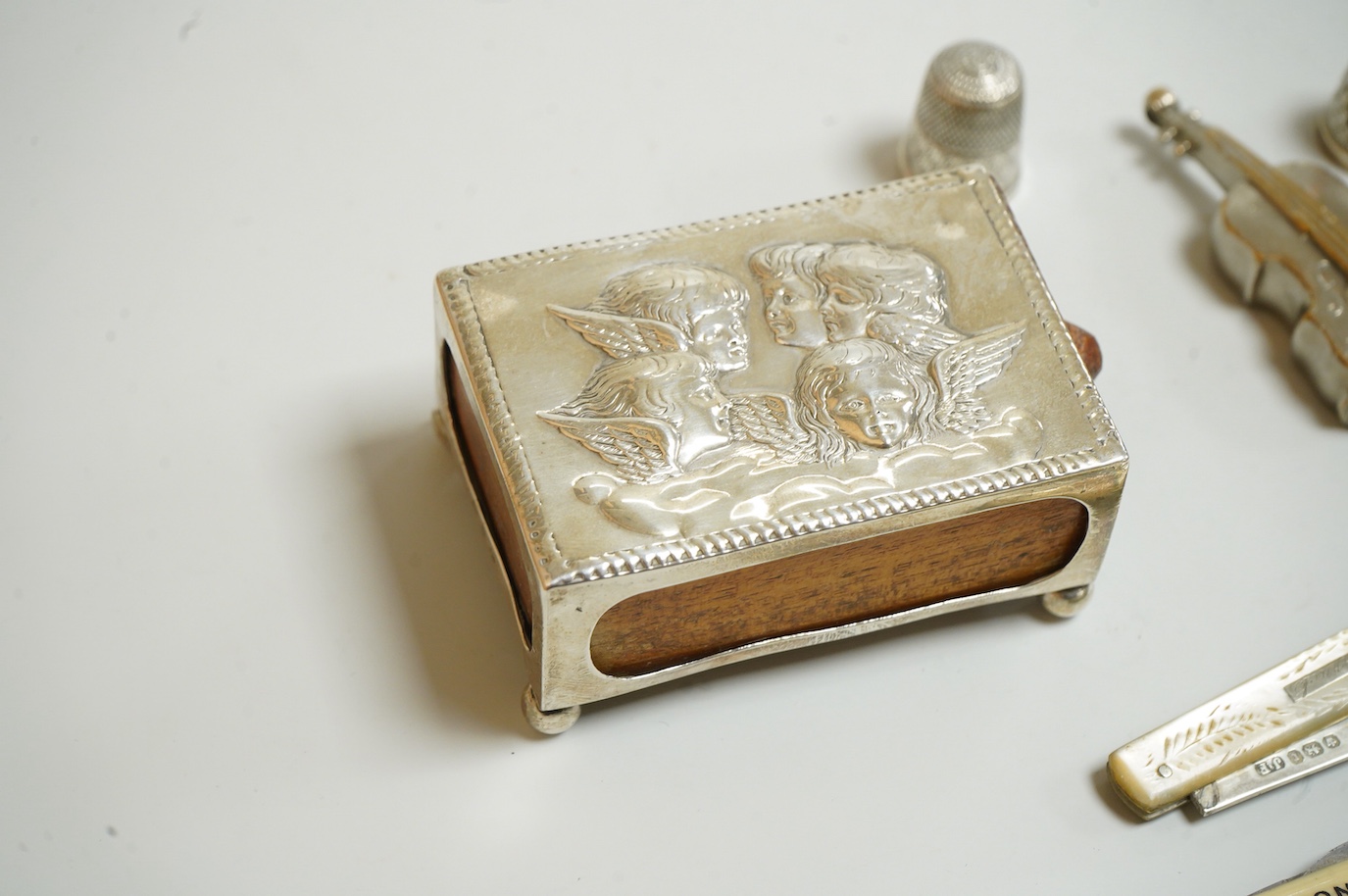A small group of silver and other items, including an Edwardian silver mounted Common Prayer book(a.f.), a silver mounted matches holder, a silver mounted glass inkwell, a silver and mother of pearl fruit knife, two thim